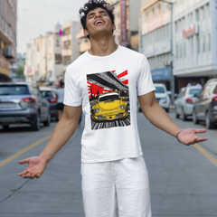 Person wearing a white t-shirt with a graphic design of a yellow car on a city street.