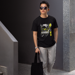 Man wearing a black t-shirt with graphic design, sunglasses, and holding a black bag in an indoor setting.