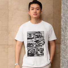 Person wearing a white t-shirt with black graphic design against a beige wall.
