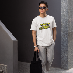 Man wearing a white t-shirt with a graphic design, holding a black bag, and standing in an indoor setting.