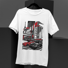 White t-shirt with a graphic design of cars and buildings on a black background