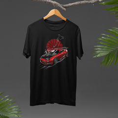 Black t-shirt with a red car graphic on a hanger against a dark background with green leaves.