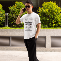 Man talking on a phone outdoors with greenery and a building in the background
