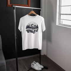 White t-shirt with graphic design on a hanger in a room with a window.