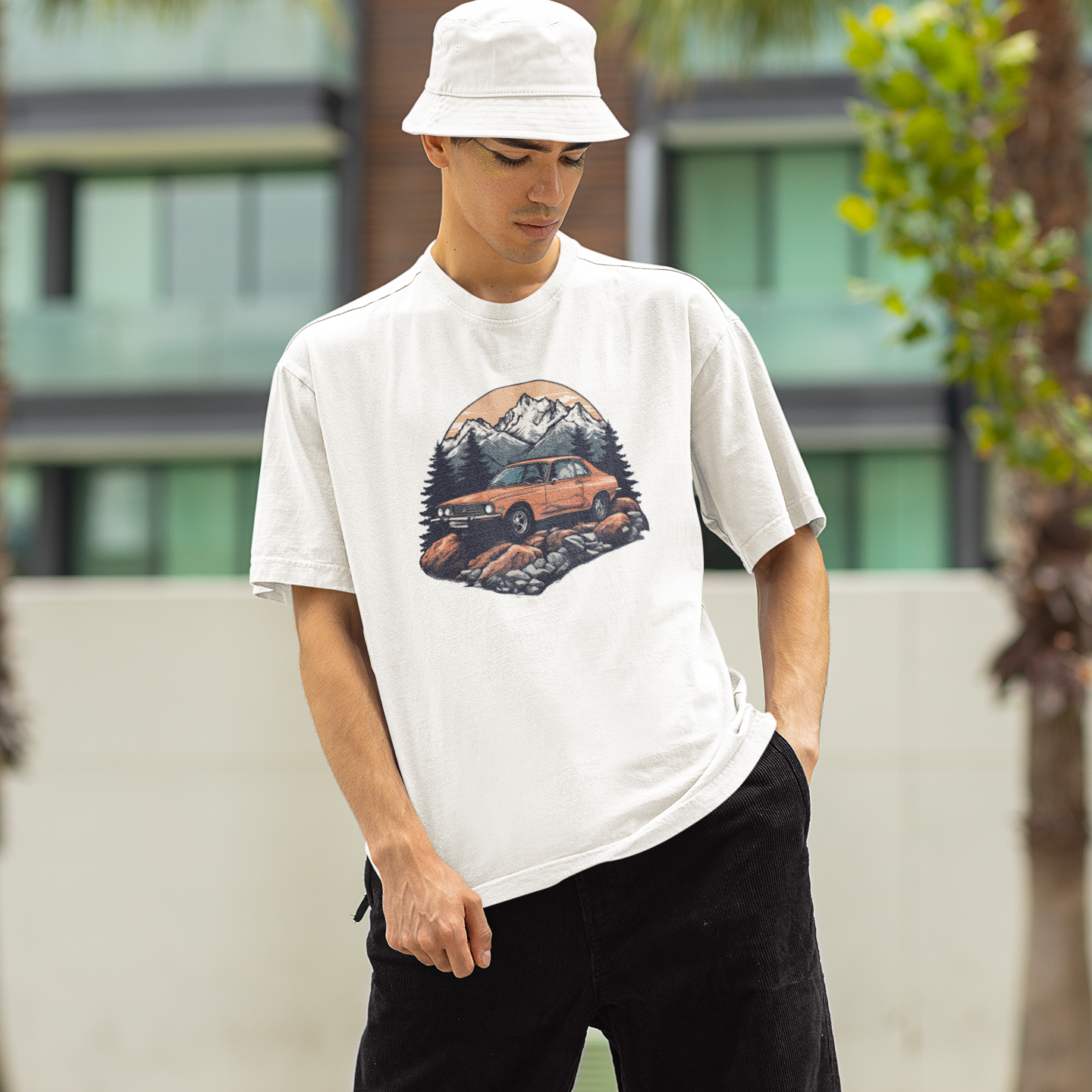 Person wearing a white t-shirt with a graphic design outdoors