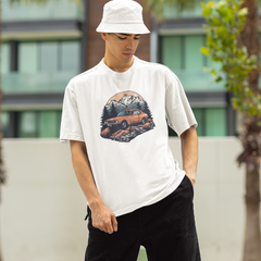 Person wearing a white t-shirt with a graphic design outdoors