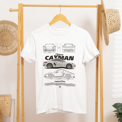 White t-shirt with car design on a wooden hanger against a white wall.