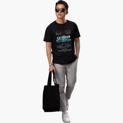 Person wearing a black t-shirt with a car design, holding a black bag on a white background