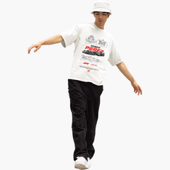 Person wearing a white t-shirt with graphics and text, black pants, and a white cap on a white background