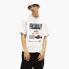 Person wearing a white t-shirt with Chevrolet graphics on a white background
