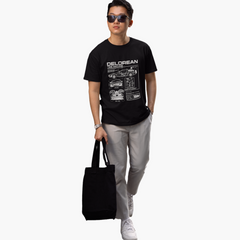 Person wearing a black t-shirt with 'Delorean' design, holding a black bag on a white background