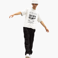 Person wearing a white t-shirt with graphic designs and text, black pants, and a white cap on a white background