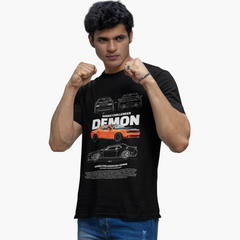 Person wearing a black t-shirt with a graphic of a car and text, on a white background