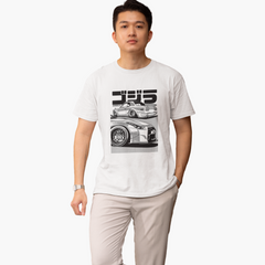Person wearing a white t-shirt with a graphic design on a plain background