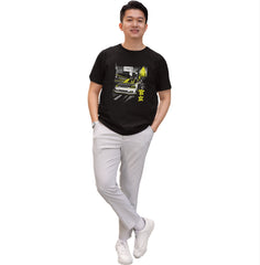 Person wearing a black t-shirt with a graphic design on a white background