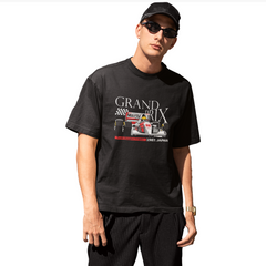 Person wearing a black t-shirt with 'Grand Prix' graphic design on a white background