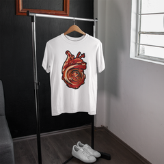 White t-shirt with a graphic design on a hanger in a room with a window.