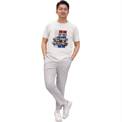 Person wearing a white t-shirt with graphic design on a plain background