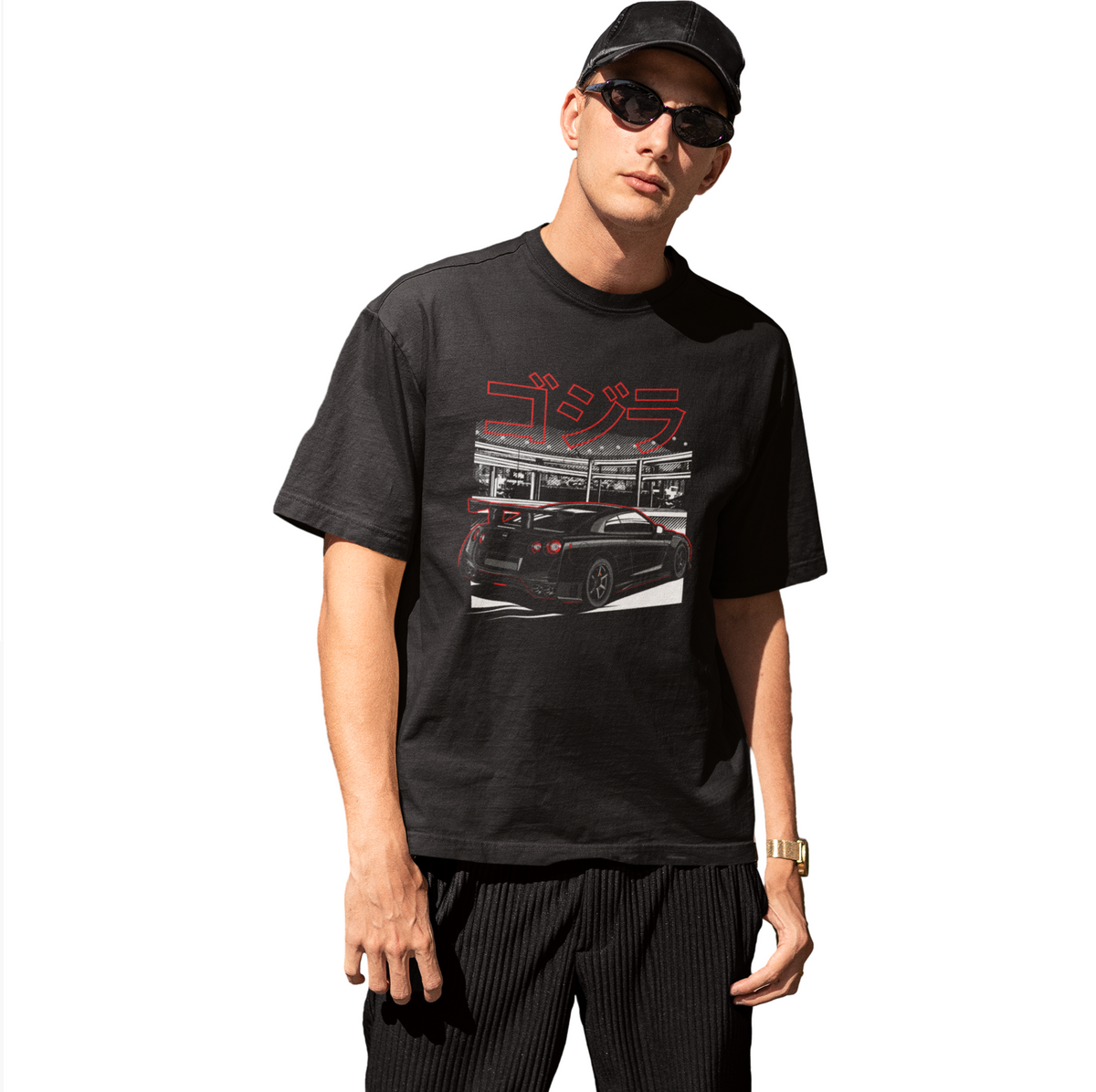 Person wearing a black t-shirt with a graphic design on a white background