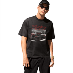 Person wearing a black t-shirt with a graphic design on a white background