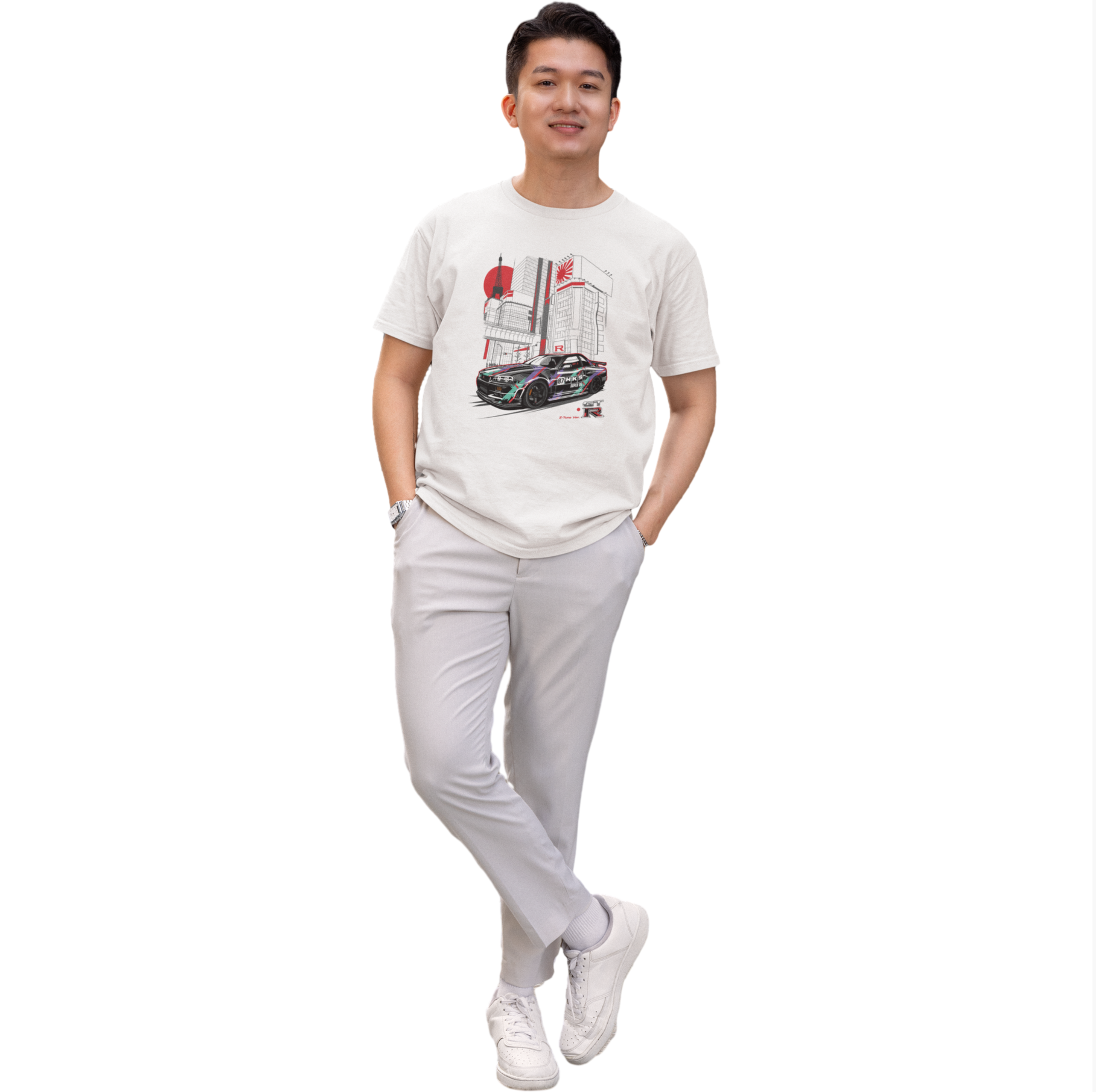 Man wearing a white t-shirt with a graphic design and light gray pants on a white background