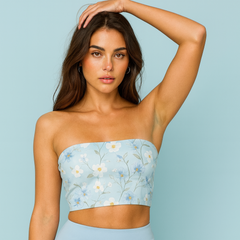 Woman wearing a light blue strapless top with floral pattern and matching skirt against a light blue background