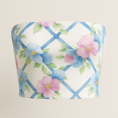 Floral-patterned fabric with blue lattice design on a beige background