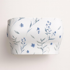 White cylindrical container with blue floral pattern on a white background