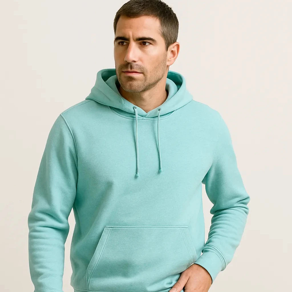 Man wearing a light blue hoodie against a beige background