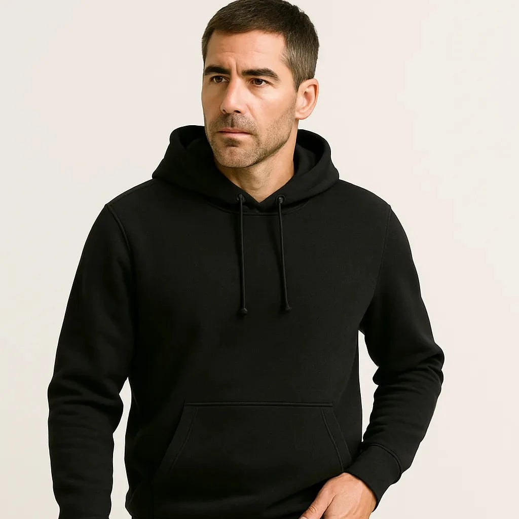 Man wearing a black hoodie against a plain background