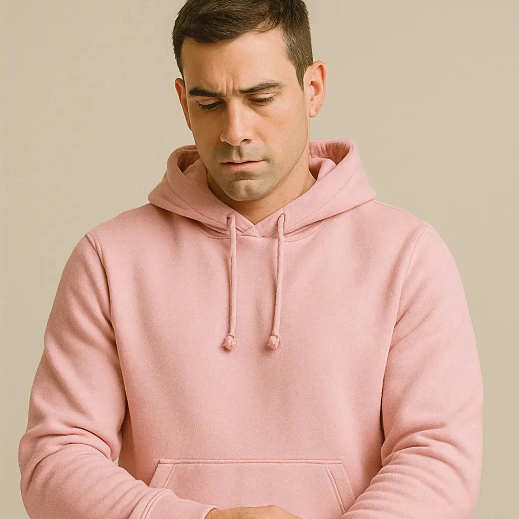 Man wearing a pink hoodie against a beige background
