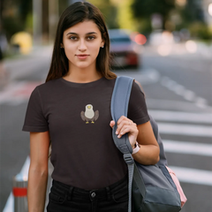 Woman wearing a black t-shirt with a graphic design, holding an apple, and carrying a gray backpack on a street.