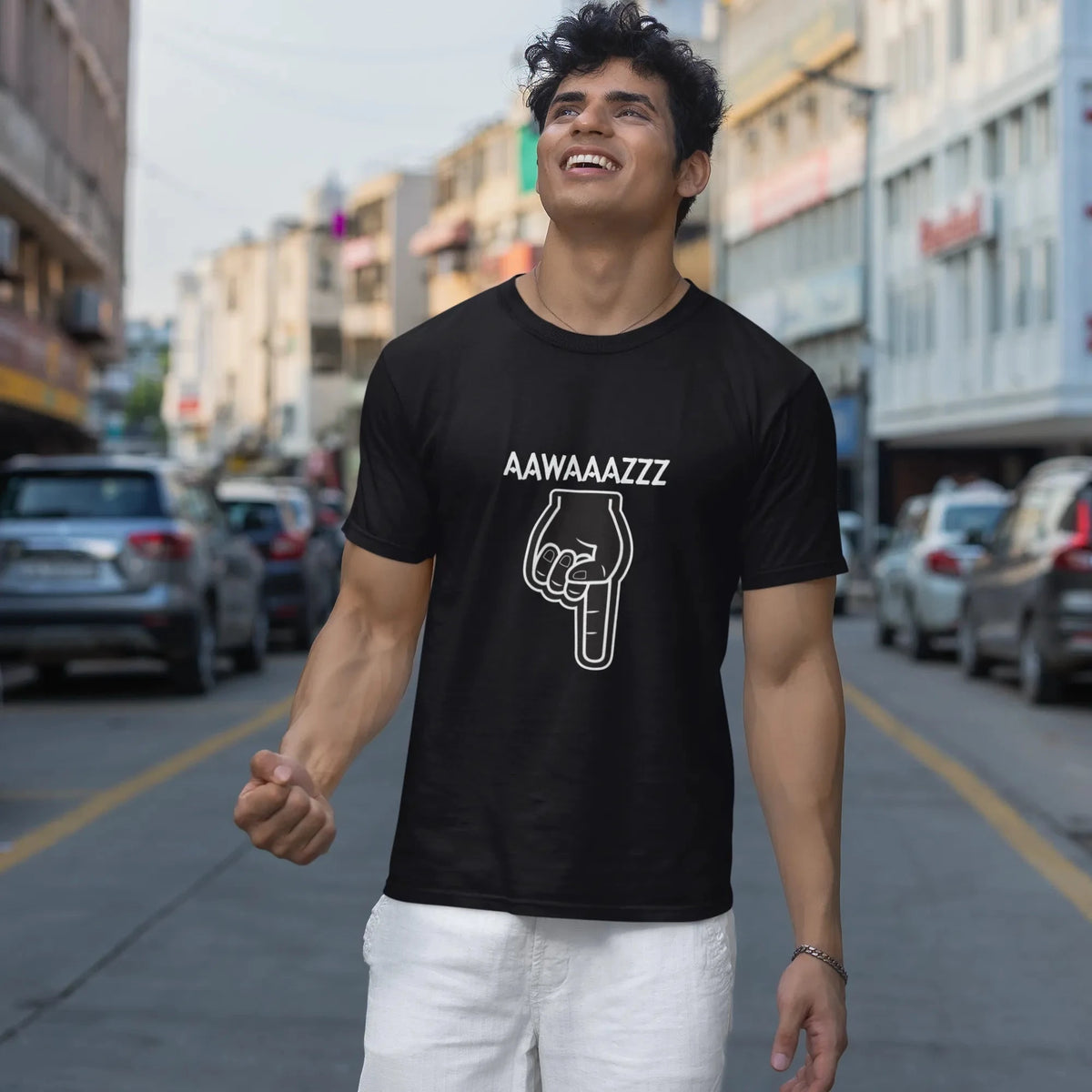Man wearing a black t-shirt with text and graphic on a city street