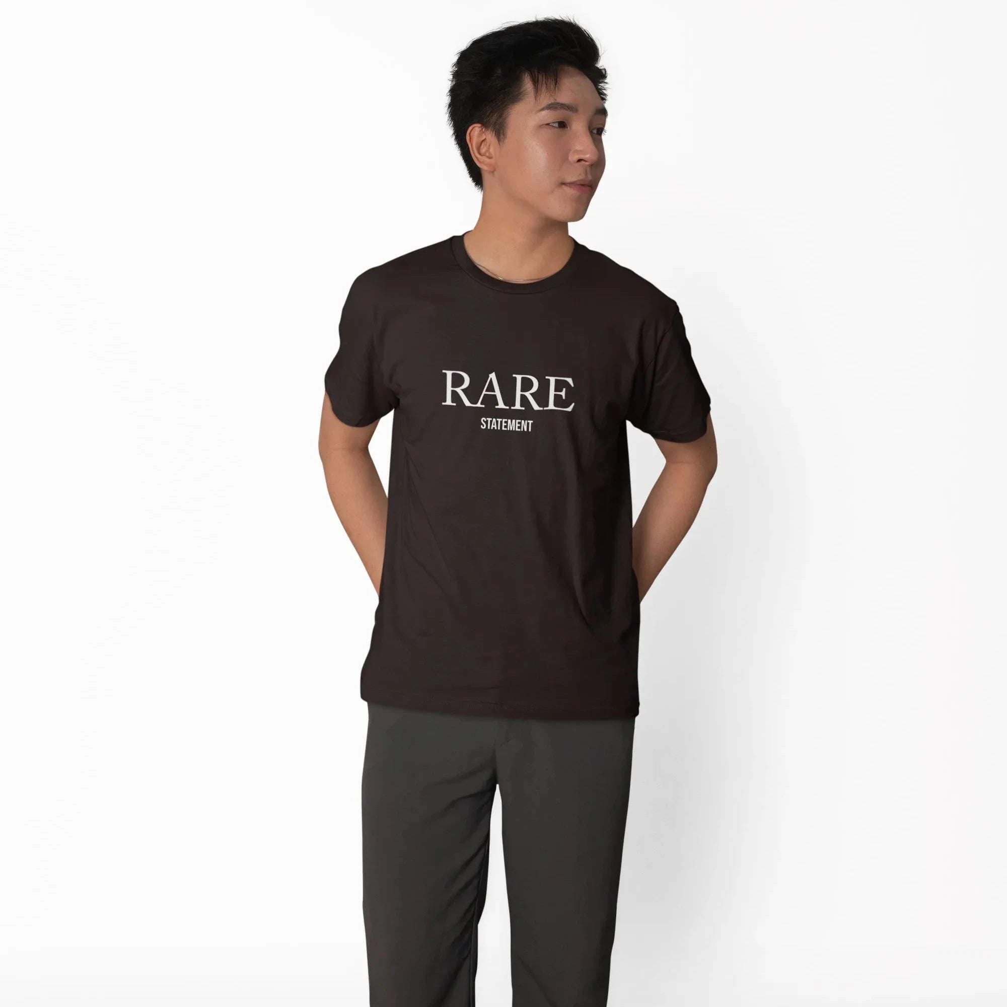 Person wearing a black 'RARE' t-shirt and dark pants on a white background