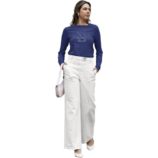 Woman wearing a blue long-sleeve shirt and white pants on a white background