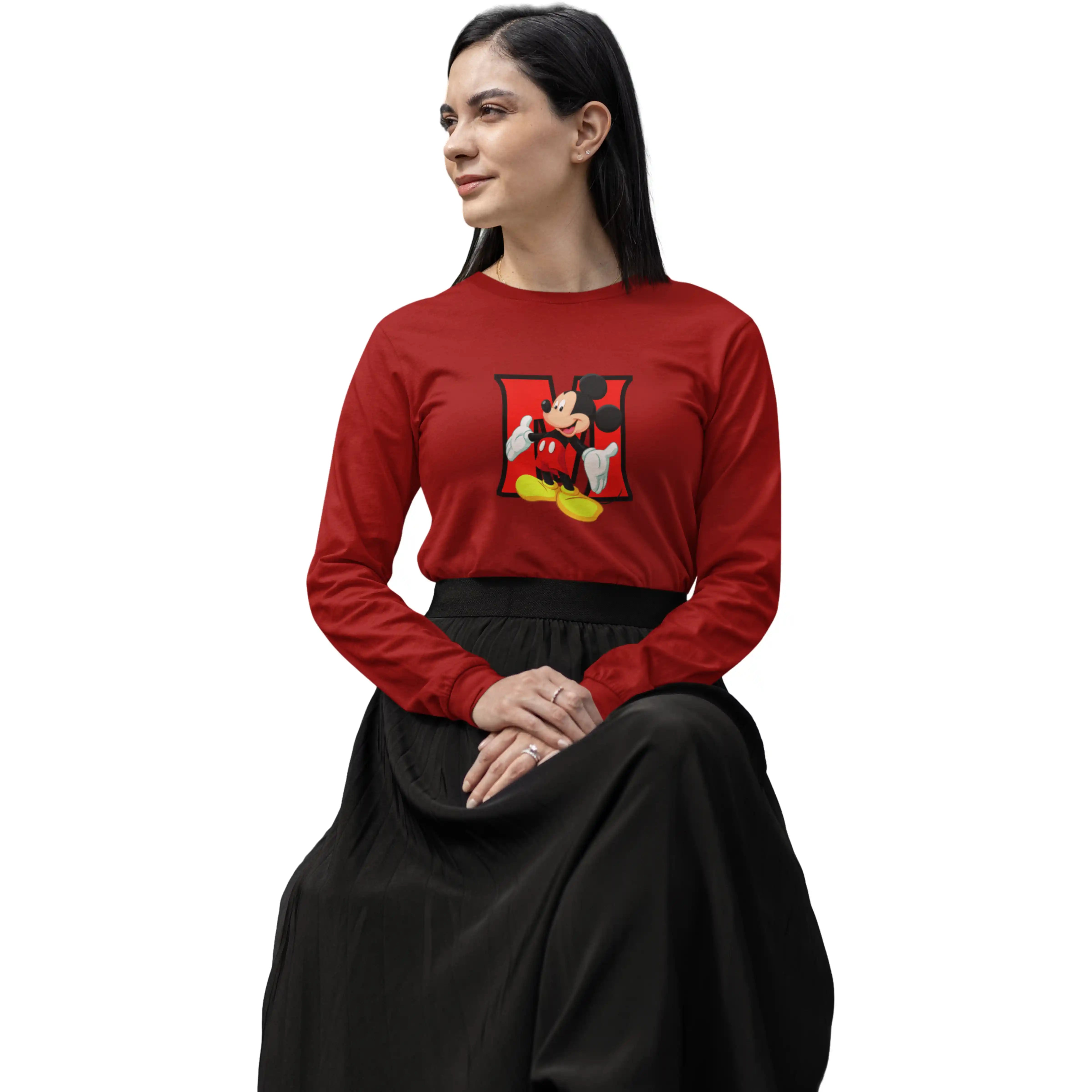 Woman wearing a red long-sleeve shirt with a graphic design on a white background