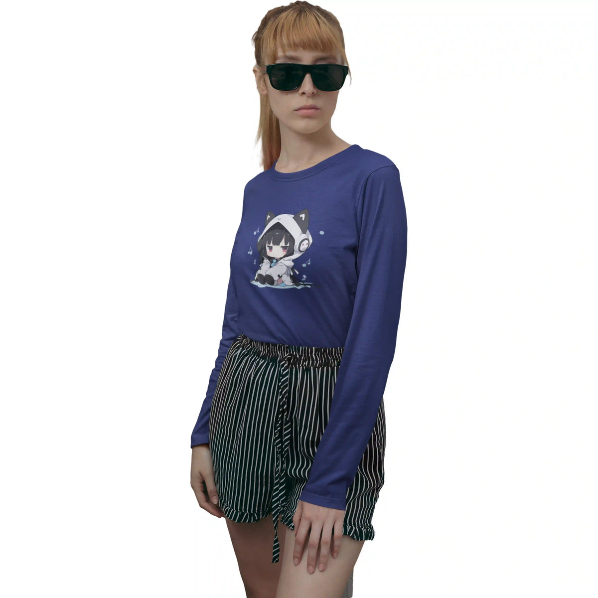 Person wearing a blue long-sleeve shirt with a graphic design and black shorts on a white background