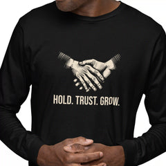Black long-sleeve shirt with a graphic of two hands shaking and text 'HOLD. TRUST. GROW.'