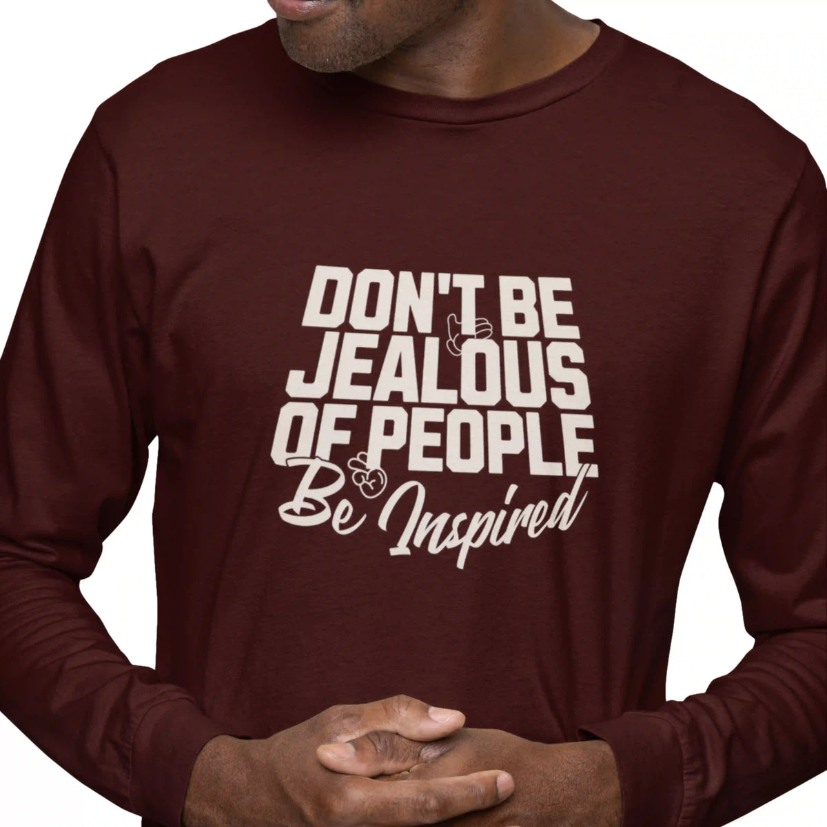 Maroon long-sleeve shirt with motivational text on a white background