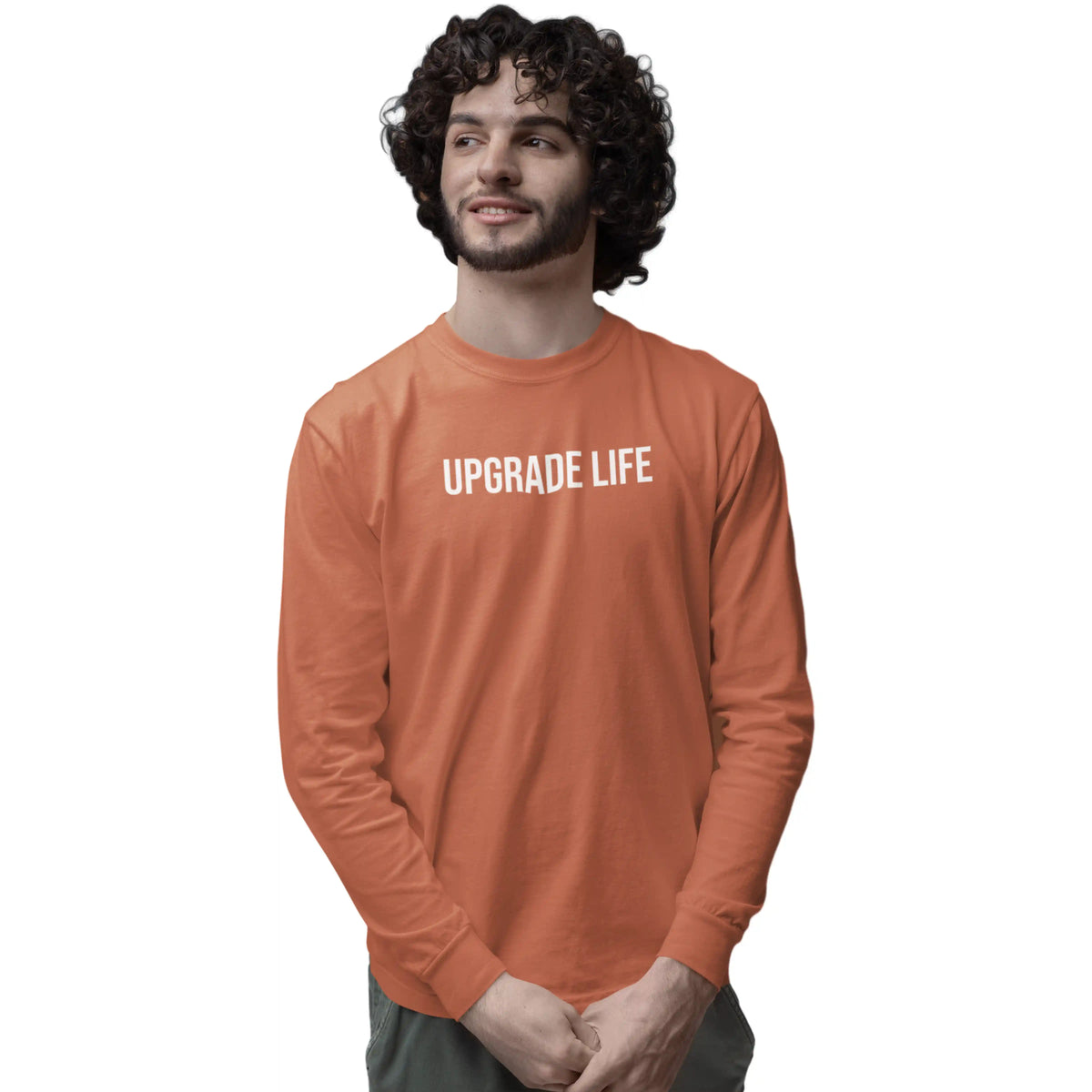 Man wearing an orange long-sleeve shirt with 'Upgrade Life' text on a white background