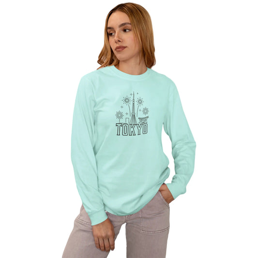 Person wearing a light blue sweatshirt with 'TOKYO' and a graphic design on a white background