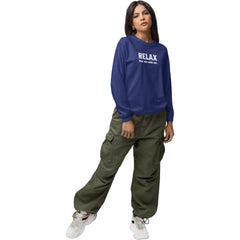 Woman wearing a blue sweatshirt with 'RELAX' text and green cargo pants on a white background