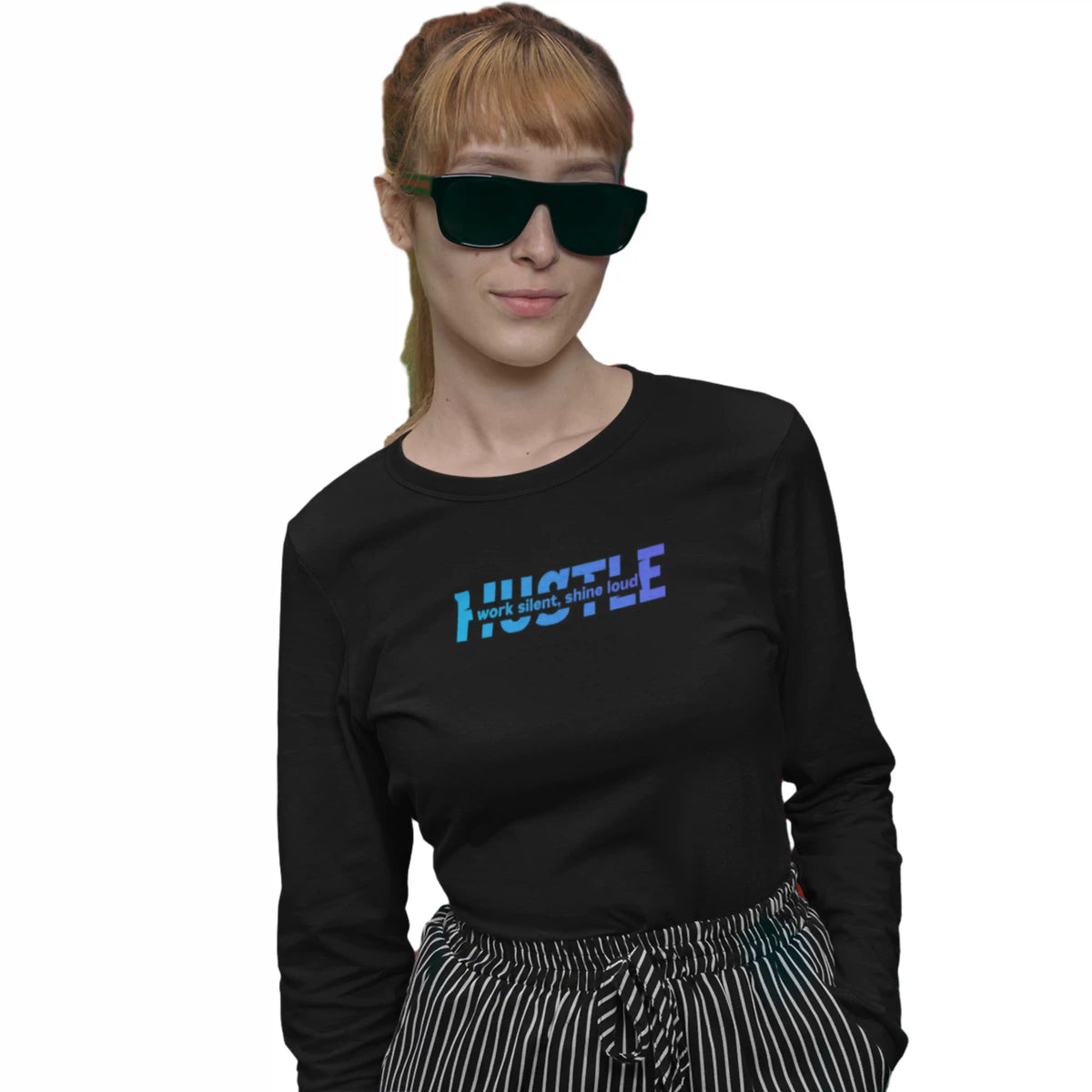 Person wearing a black long-sleeve shirt with 'HUSTLE' text, sunglasses, and striped pants on a white background