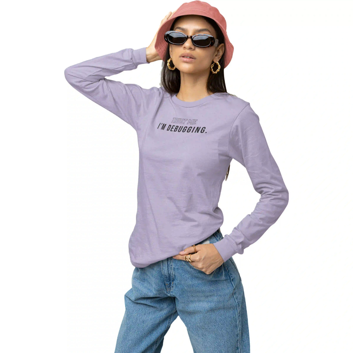 Person wearing a purple long-sleeve shirt with text, blue jeans, and a pink hat on a white background