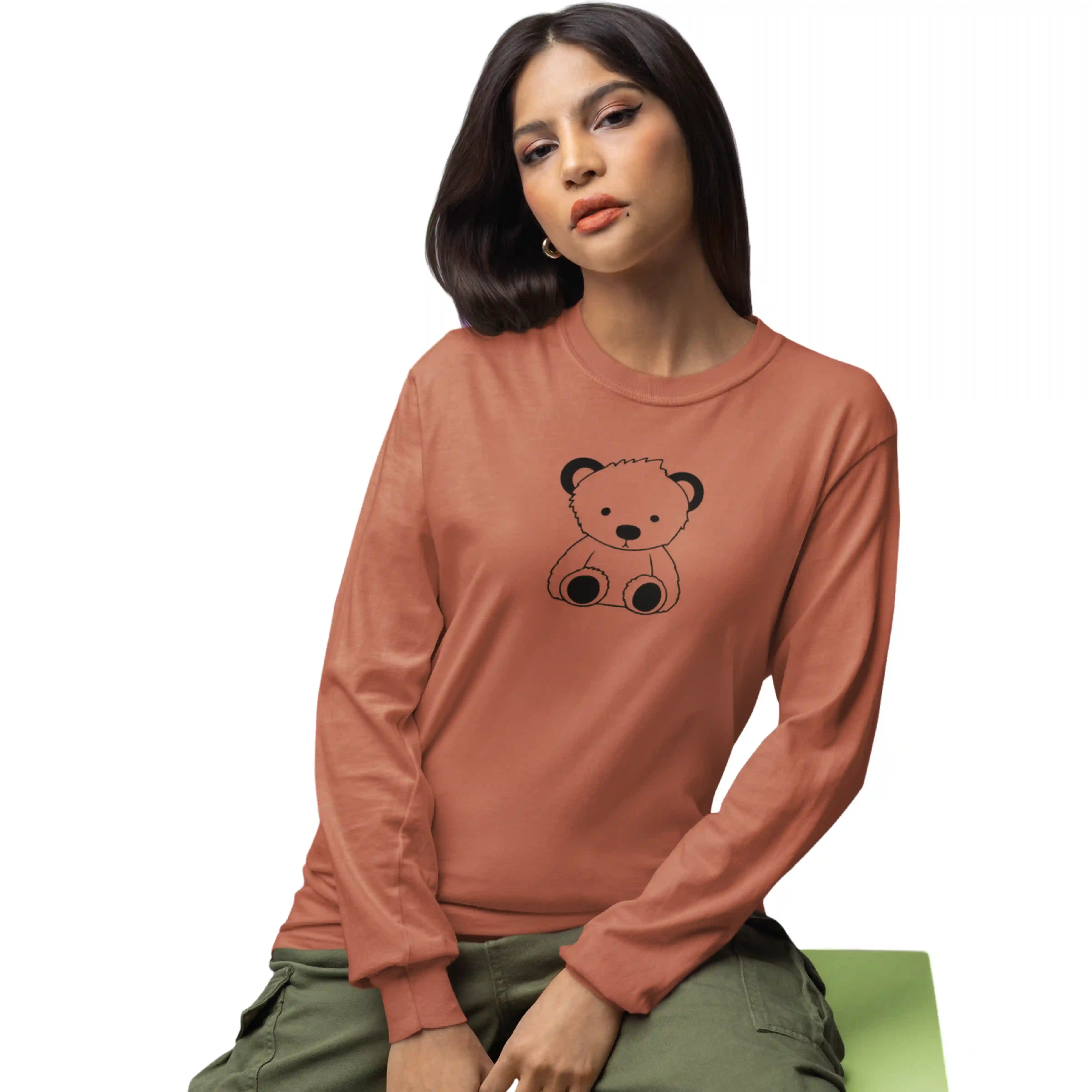 Woman wearing a brown long-sleeve shirt with a bear graphic on a white background