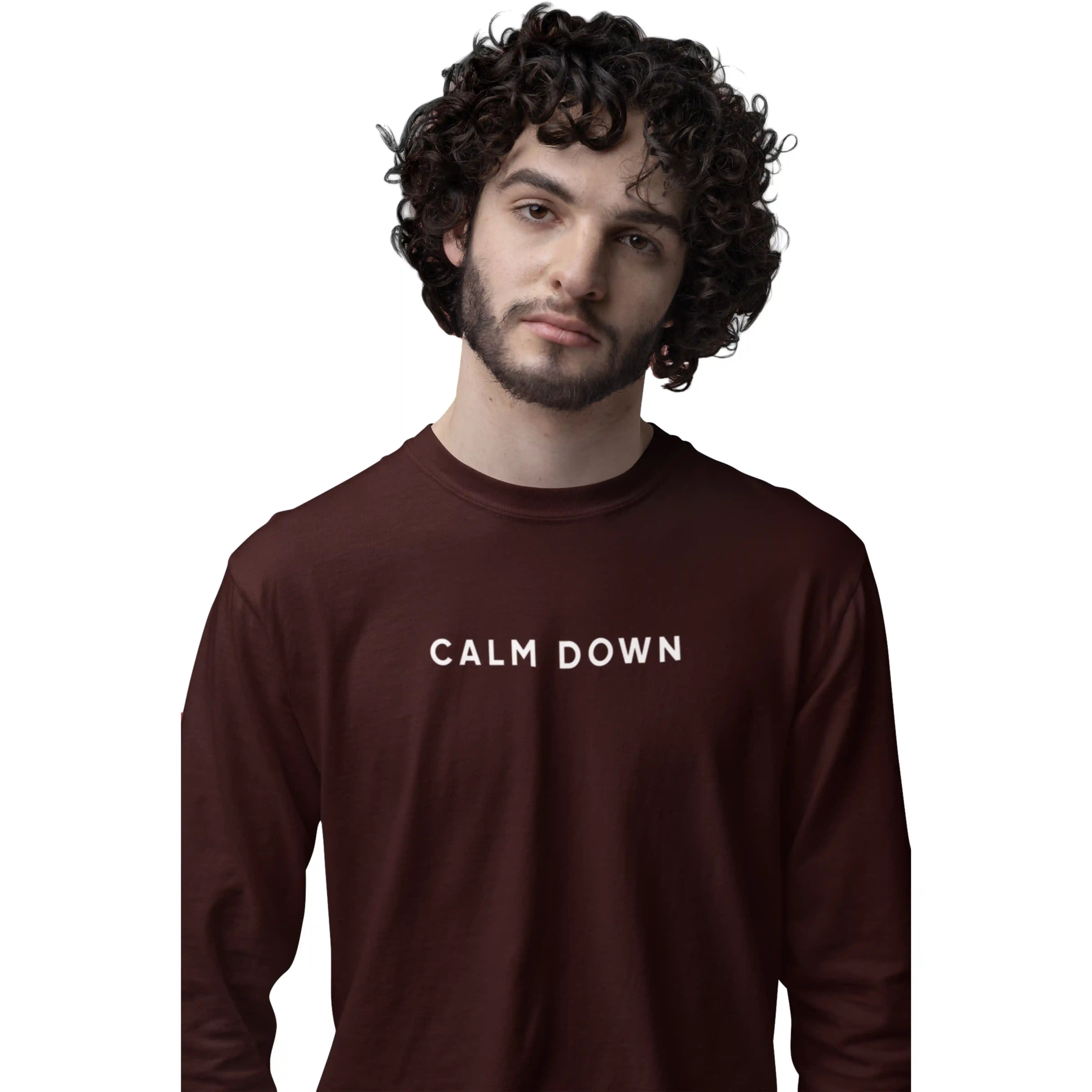 Man wearing a brown sweatshirt with 'CALM DOWN' text on a white background