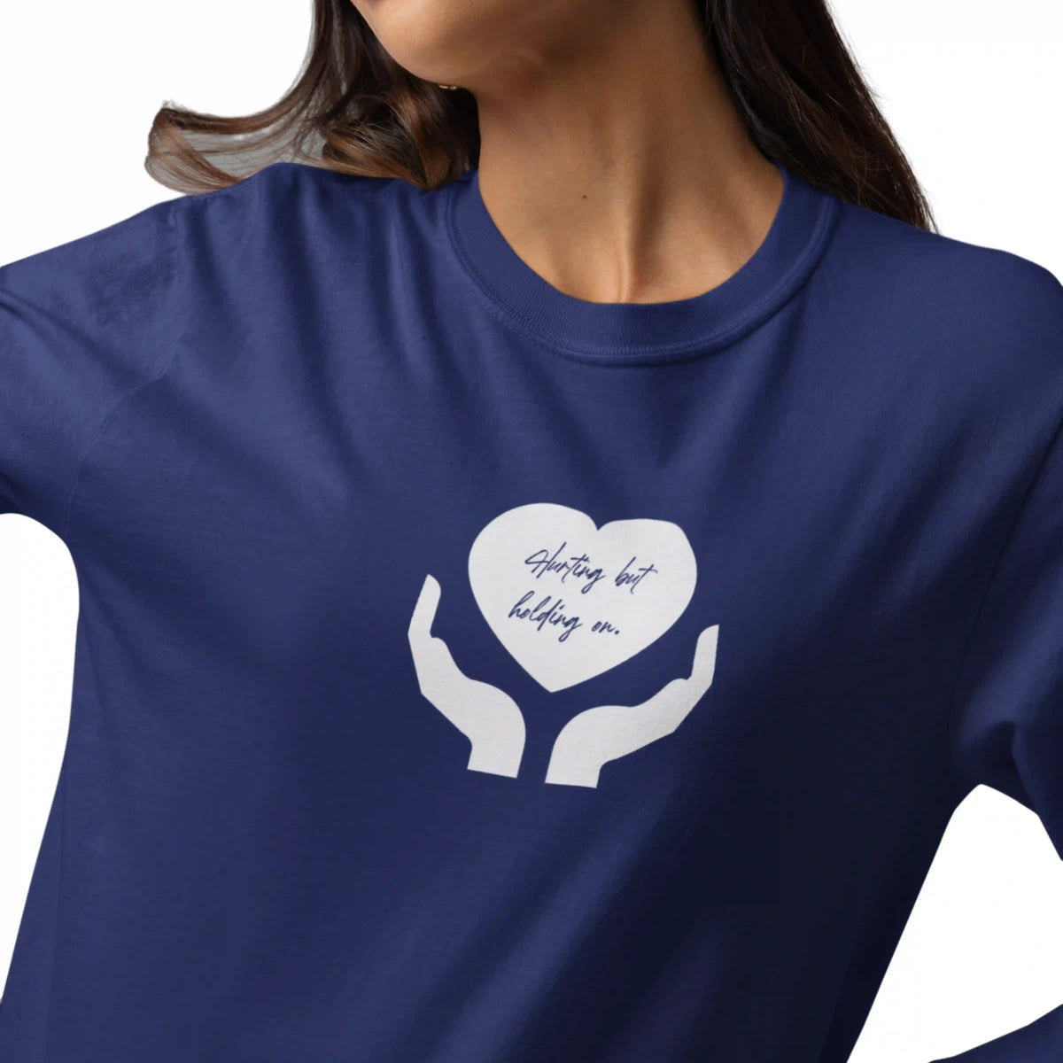 Navy blue t-shirt with white graphic of hands holding a heart and text on a white background