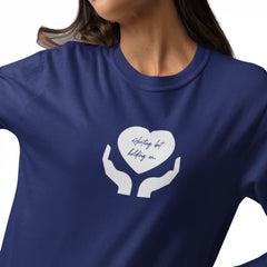 Navy blue t-shirt with white graphic of hands holding a heart and text on a white background