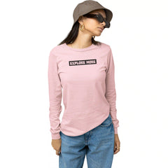 Person wearing a pink long-sleeve shirt with 'EXPLORE MORE' text, blue jeans, and a brown hat on a white background