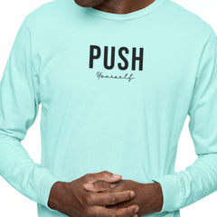 Person wearing a light blue long-sleeve shirt with 'PUSH Yourself' text on a white background